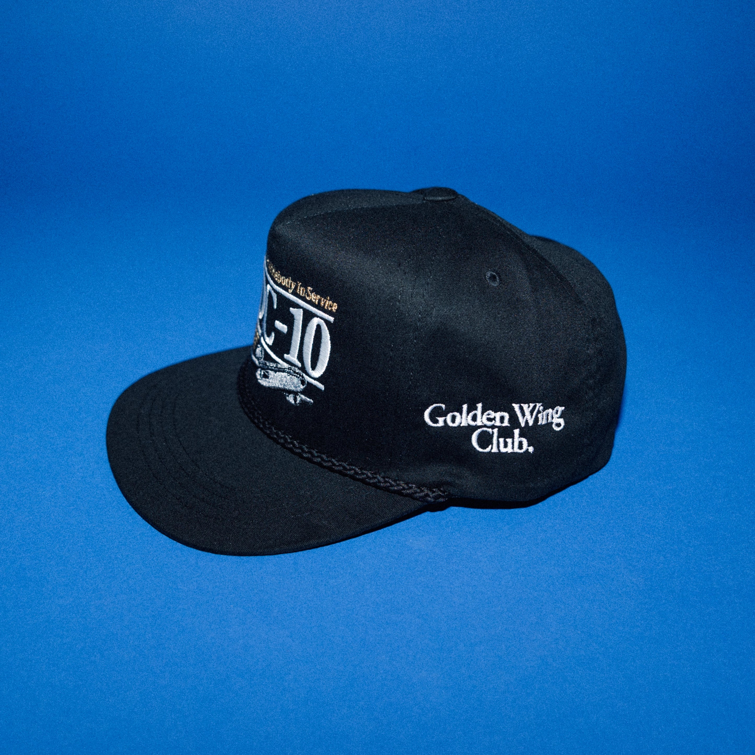 Golden Wing Club DC-10 cap — black with white and gold embroidered DC-10 aircraft insignia