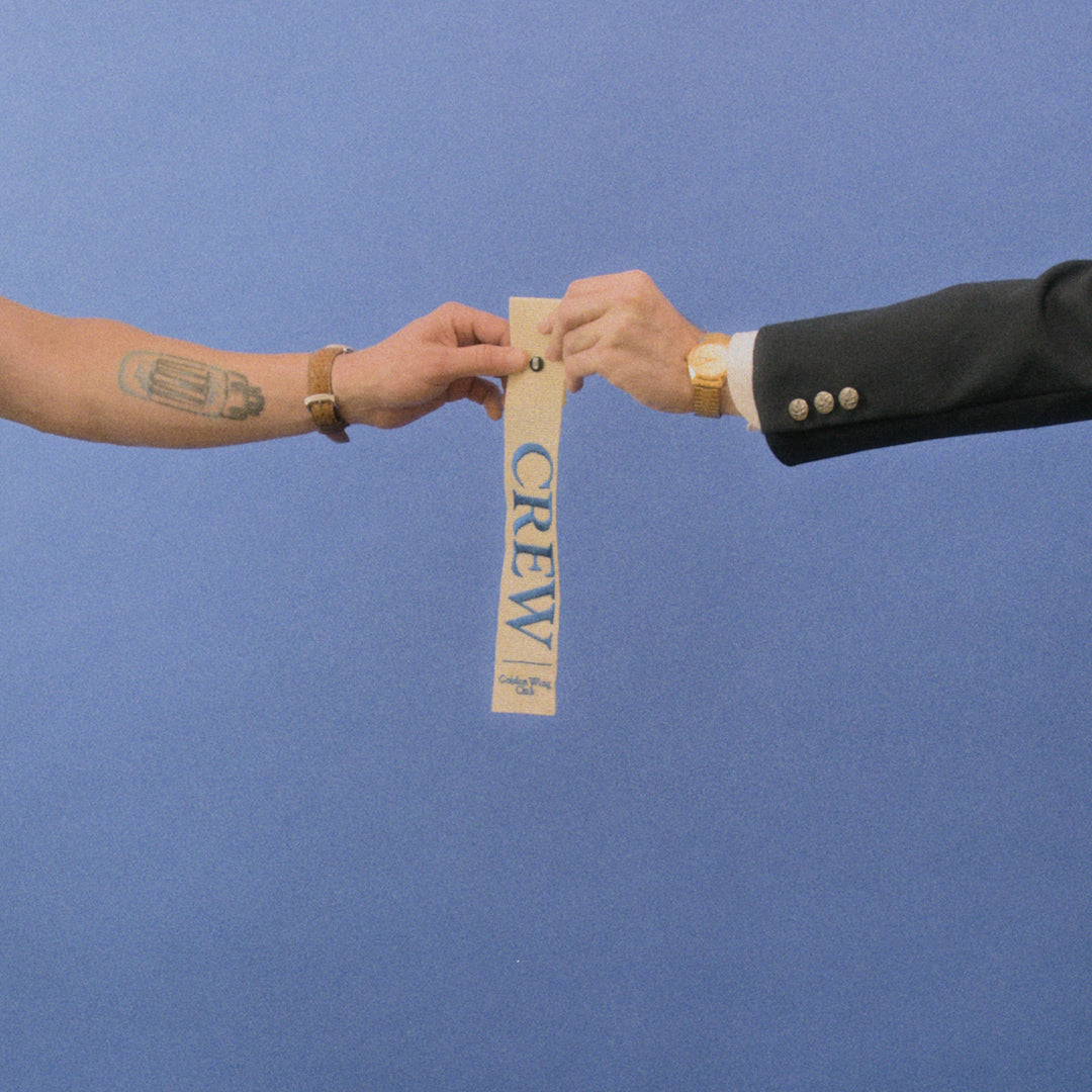 Crew Strap from golden wing club being handed to member